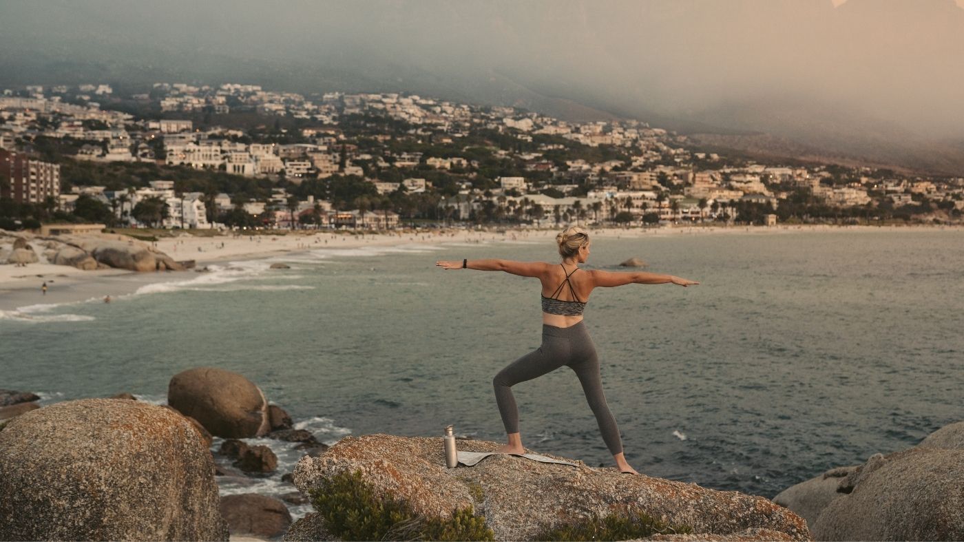 A woman moving outdoors by the sea