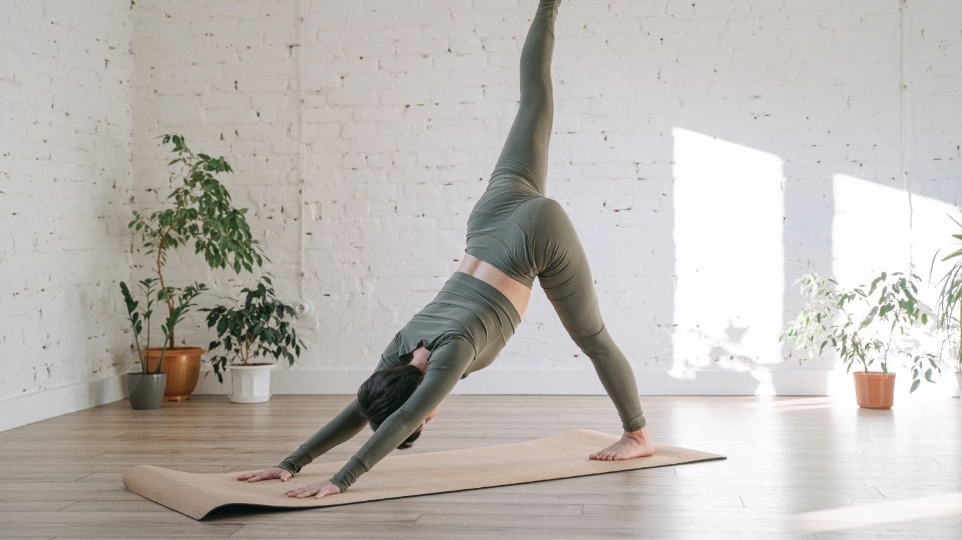 A woman practising a gentle movement indoors