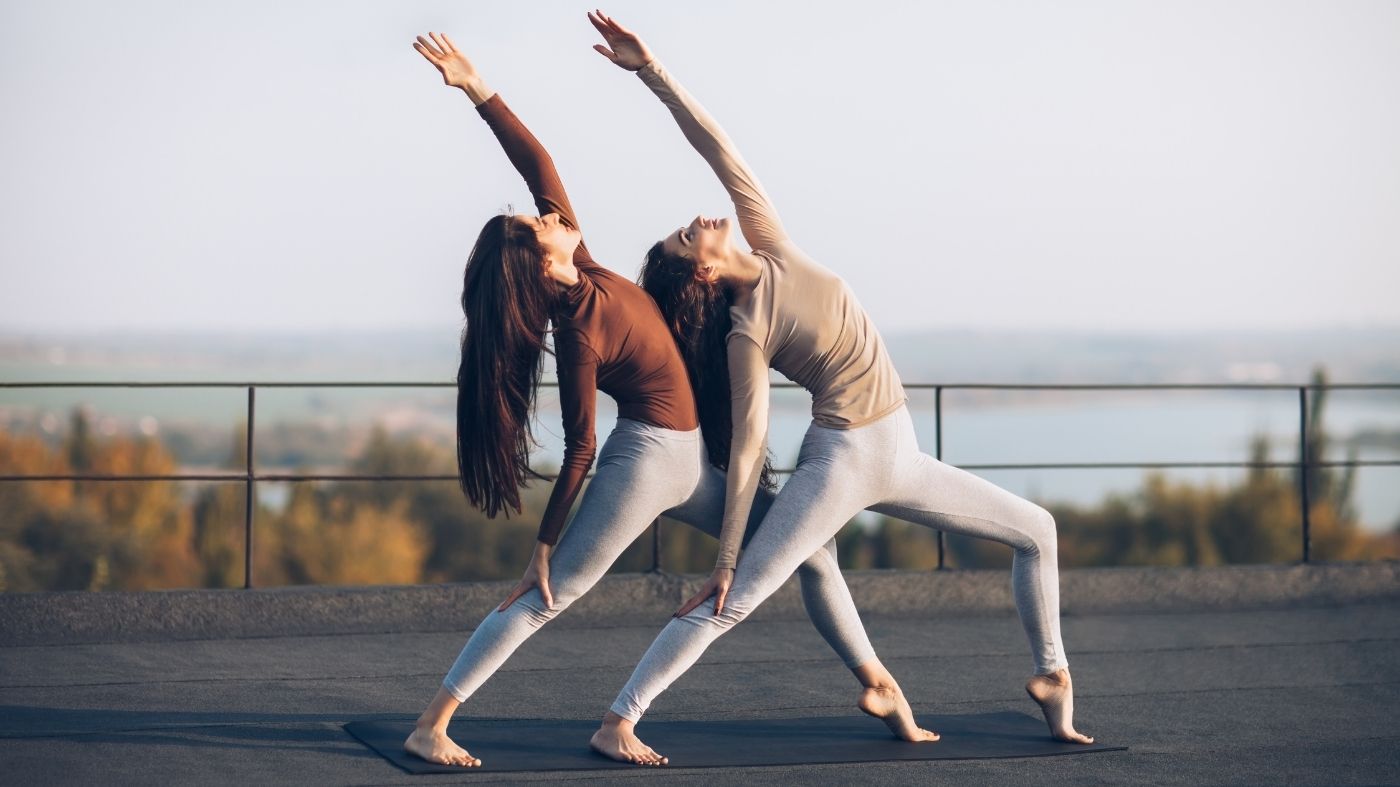Two women moving together in a bright studio